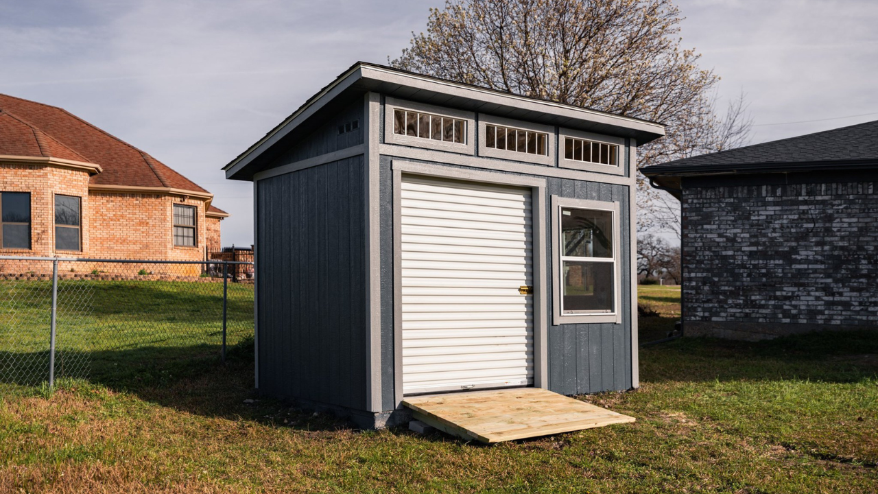 single slope shed with a ramp and a rollup door